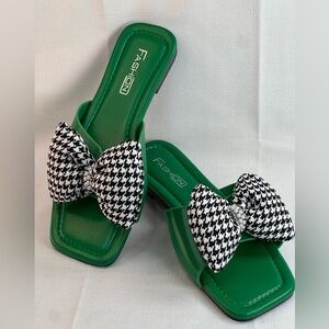 Green man-made slides with hounds tooth bow.